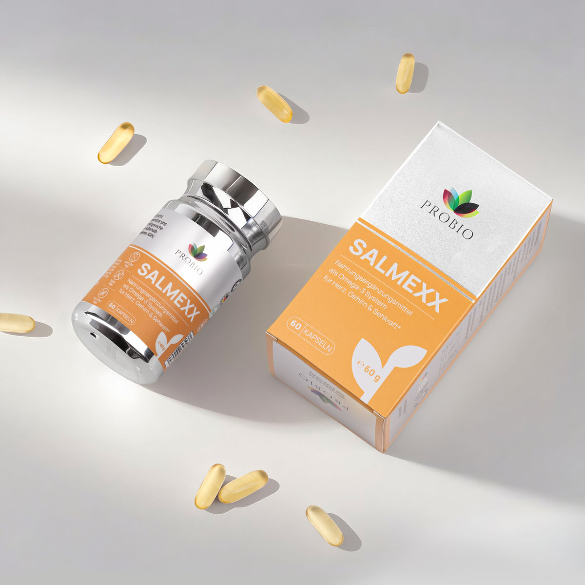 Probio SALMEXX Omega-3 Kapseln – Nahrungsergänzung für Herz, Gehirn und Sehkraft, 60 Kapseln im silbernen Glas mit orange-weißer Box, umgeben von einzelnen goldgelben Softgel-Kapseln.